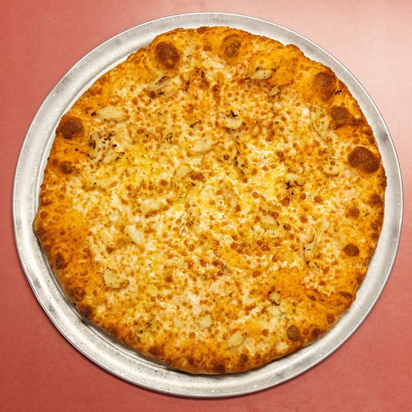 Golden-crusted pizza with melted cheese and savory white toppings on a metal pan.